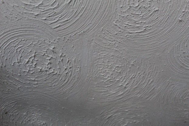Close-up of a ceiling finished with a swirl-pattern textured coating